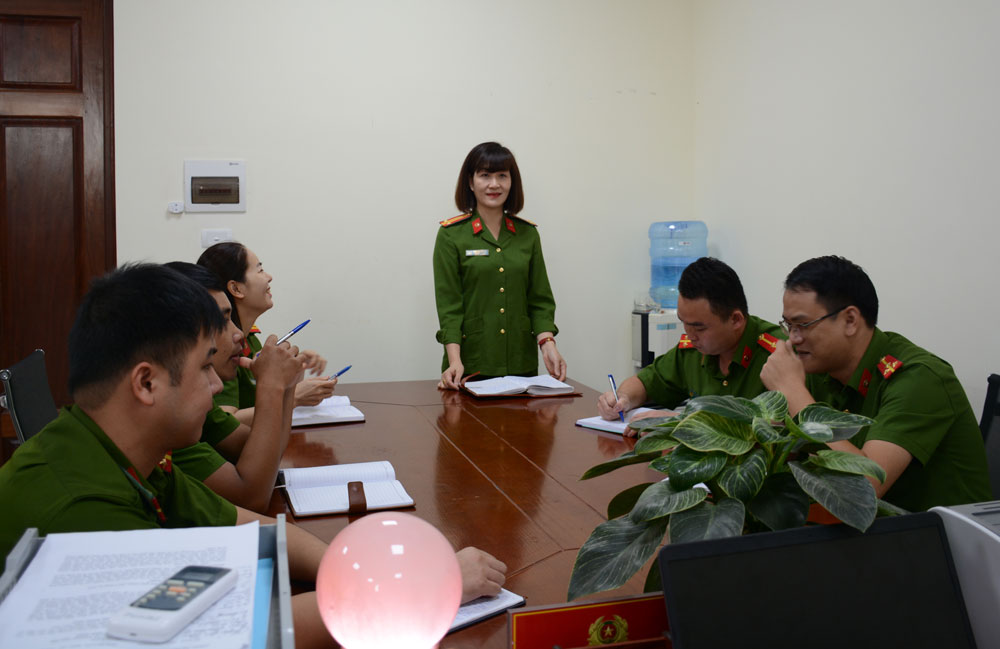 Trung tá Ngô Thị Dương trao đổi kinh nghiệm phá án với đồng nghiệp.