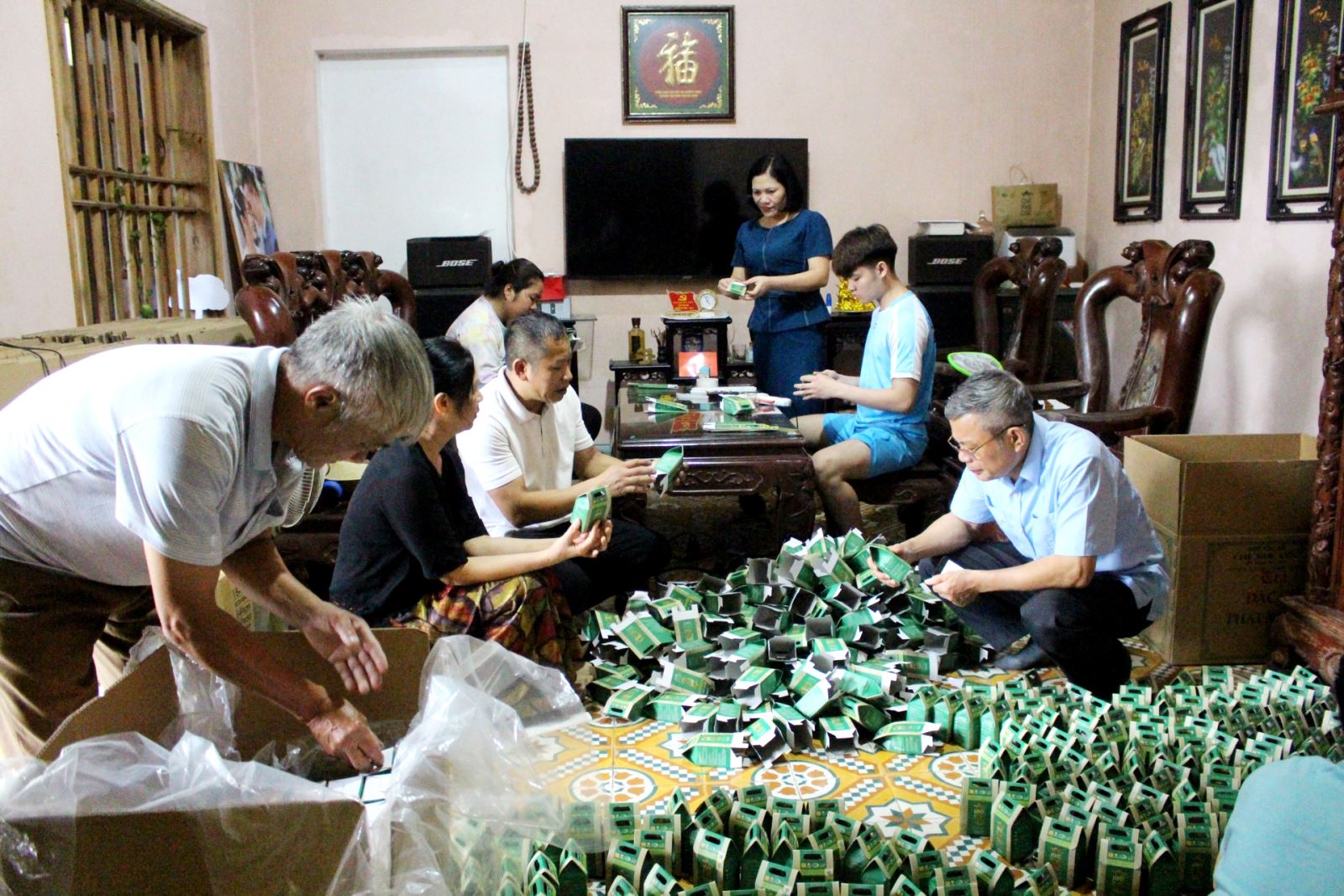  Members of KheCoc Safe Tea Cooperative packs dried tea products for export.