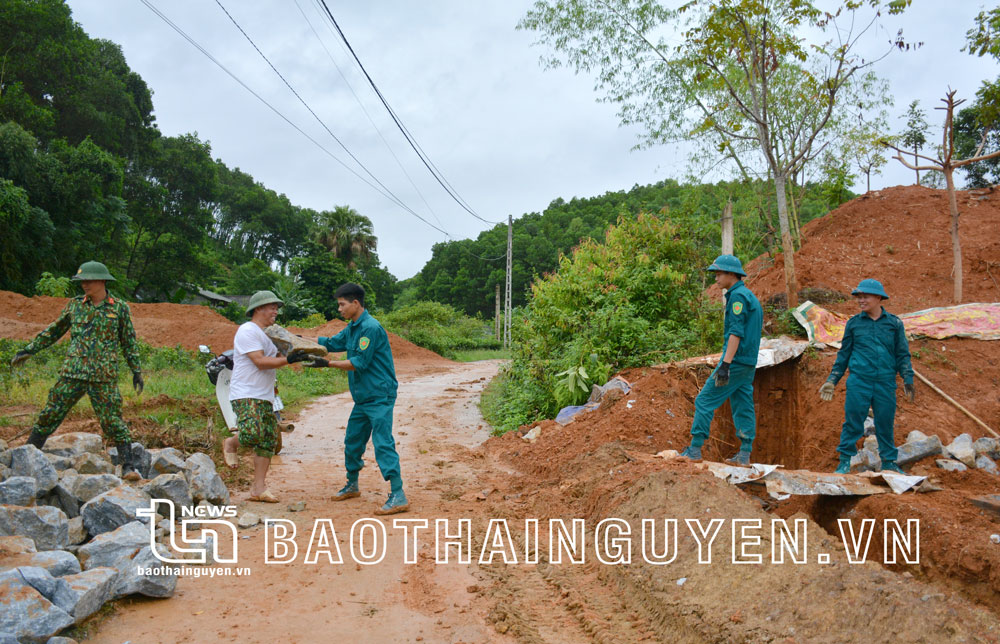  Lực lượng DQTV huyện Định Hoá tham gia hỗ trợ làm đường giao thông trên địa bàn thị trấn Chợ Chu.